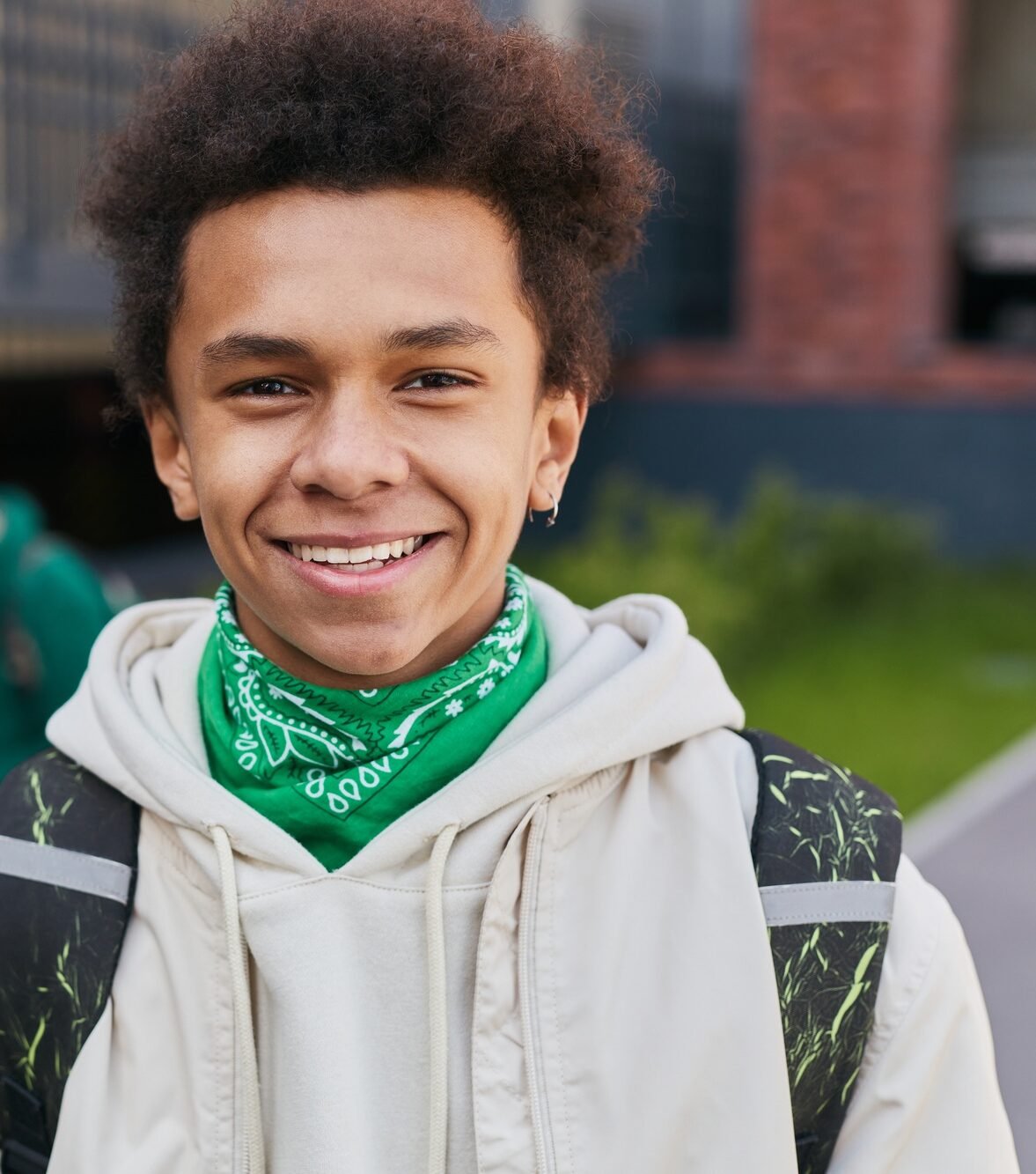 African teenage student standing outside