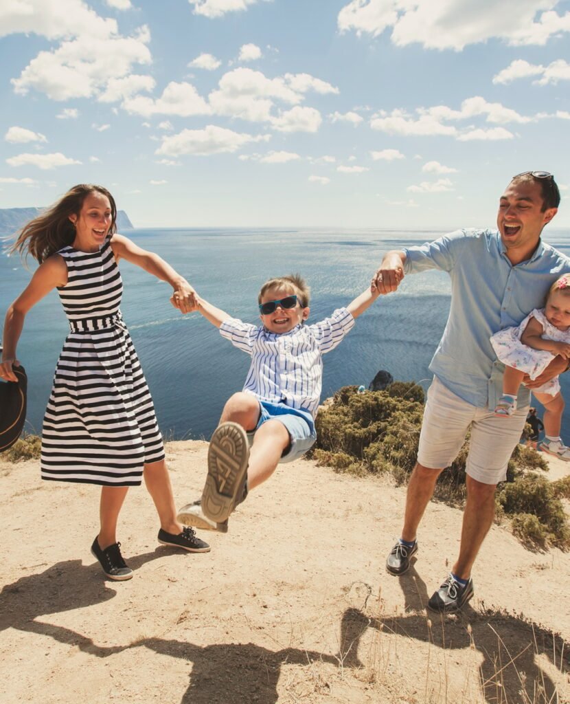 https://safelyinsure.net/wp-content/uploads/2025/07/happy-family-of-four-walking-in-the-mountains-family-concept-family-trip--e1753451676270-830x1024.jpg